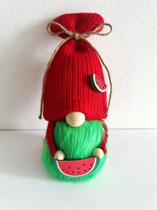 Detailed close-up of knitted watermelon gnome with red hat and green plush beard