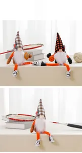 Detail of sport-themed long-legged gnomes holding basketball and rugby ball figurines