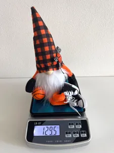 Detailed view of basketball gnome plush doll on digital scale showing 129.5g weight