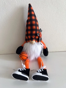 Detail of basketball themed gnome featuring orange checkered hat and miniature shoes