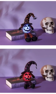 Detail of LED glowing pumpkin elf with wizard hat and spider pendant for Halloween decor