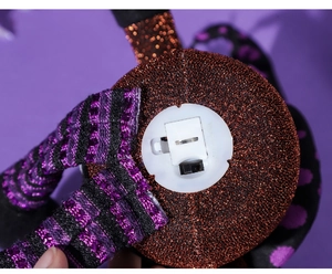 Detail view of the battery compartment and toggle switch on the Halloween pumpkin light decor
