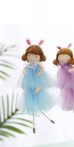 Detail showing felt rabbit dolls with blue and purple tulle skirts and lace necklines