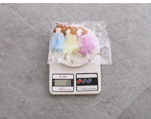 Set of three ballet fairy dolls with rabbit ears being weighed at 18 grams