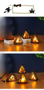 Close-up of Halloween LED lanterns with pumpkin and witch silhouettes for table decor