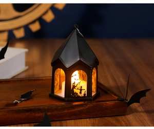 Close-up of Halloween lantern featuring spooky silhouettes of crows and pumpkin scenes
