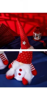 Detail of plush Christmas gnome with red knitted star hat and thick white beard