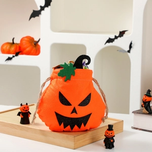 Halloween pumpkin drawstring gift bag made of orange velvet with green leaf and spooky face