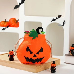 Halloween pumpkin drawstring treat bag with smiley face and candy in a festive set
