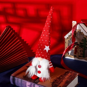 Festive Christmas gnome doll with red star hat on vintage books for holiday decoration