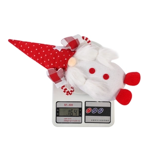 Christmas gnome plush toy detail showing weight of 164g on a digital scale