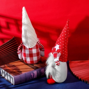 Pair of Christmas gnomes with knitted hats and plaid bodies on a red background
