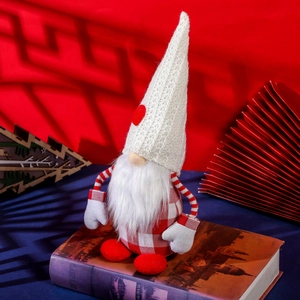 Nordic Christmas gnome plush with red heart hat and plaid body on classical book