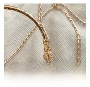 Detailed close-up of golden metal frame with floral carving and red velvet texture
