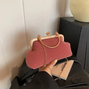 Pink velvet clutch bag with gold dots, metal handle and detachable chain strap