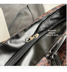 Detail of the smooth metal zipper closure on the leopard print tote bag interior