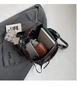 Detailed interior of leopard print tote bag showing storage capacity for tablets and umbrellas