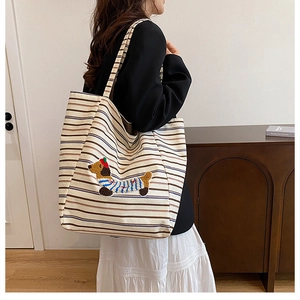 Side view of large canvas tote bag with brown stripes and plush dachshund embroidery
