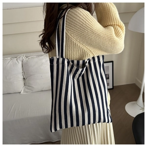 Detail of blue and white striped canvas tote bag showing thick durable fabric texture