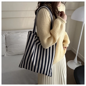 Close-up of a striped canvas tote bag showing the vertical pattern and soft fabric texture