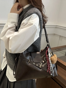 Vintage dark brown leather tote bag with stylish bear charm and metal buckle detail