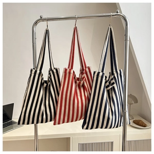 Minimalist striped canvas tote bag in black, red, and navy for daily commute