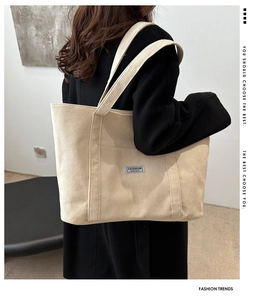 Close-up of off-white corduroy tote bag featuring a minimalist fashion instinct label