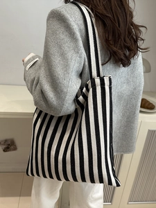 Classic black and white striped canvas tote bag for women showing large capacity and style