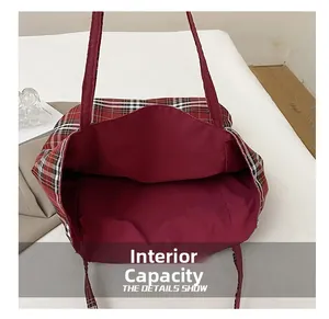Internal capacity of the large plaid canvas tote bag showing red fabric lining details