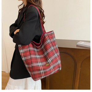 Red checkered canvas tote bag shown on model highlighting the large capacity and style