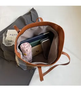 Detailed view of the spacious inner compartment of the plaid wool tote bag with zipper pocket