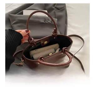 Interior view of brown leather bucket bag showing capacity for phone and wallet