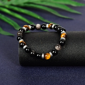 Natural Silver Obsidian and Tiger Eye planet bead bracelet with astronaut pendant on stand