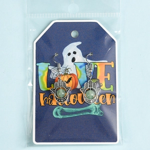 Halloween Hamsa Hand earrings with green natural crystal stone on festive display card