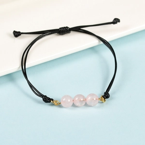 Bracciale minimalista in corda nera con tre perle di cristallo rosa e nodo
