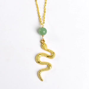 Golden snake pendant necklace with green crystal bead on a minimalist gold chain