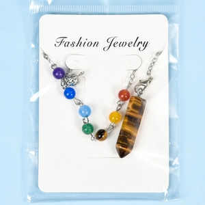 Seven chakra stone necklace with tiger eye hexagonal column pendant on jewelry card