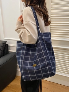 British style blue plaid canvas tote bag with gold handmade plate shown on shoulder