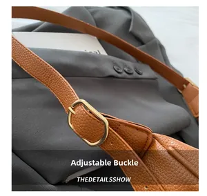 Macro detail of brown leather bag strap with golden adjustable metal buckle