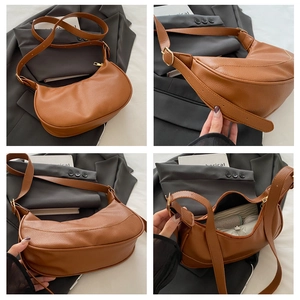 Detailed side view of brown litchi pattern leather crescent bag showing internal capacity