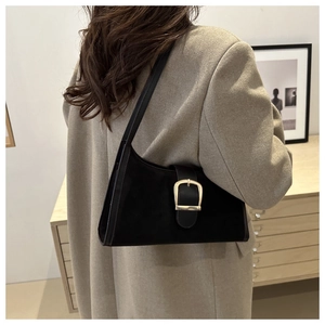 Chic black matte leather hobo bag with large silver metal buckle on a shoulder strap