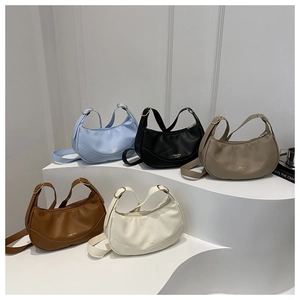 Five assorted colors of leather half-moon shoulder bags displayed on geometric pedestals