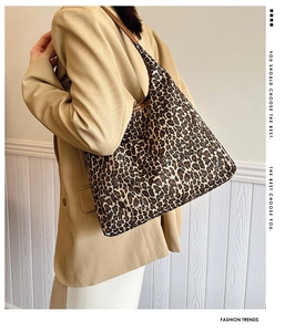 Close-up of leopard print tote bag paired with khaki blazer for urban office style