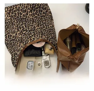 Interior view showing the large capacity of the leopard print tote with daily essentials