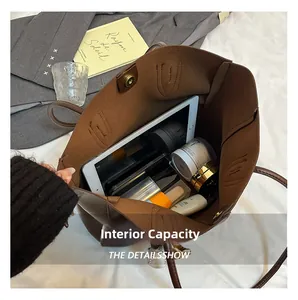 Detail view of large tote bag interior capacity showing tablet and daily essentials