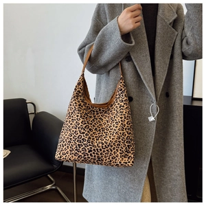 Detailed view of fashionable leopard print tote bag paired with a long grey wool coat