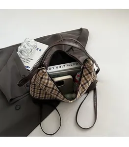Interior view of spacious plaid tote bag showing capacity for books and umbrella