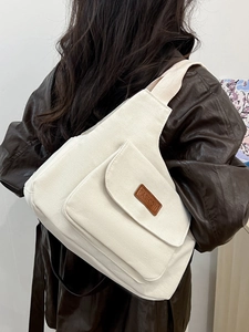 Minimalist beige canvas crossbody bag with front pocket and fashion leather patch