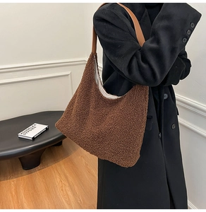 Detail of plush lamb wool tote bag with brown leather shoulder strap in a minimalist setting