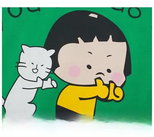 Close-up of high-quality rubber printing featuring a cute cartoon girl and cat on green fabric